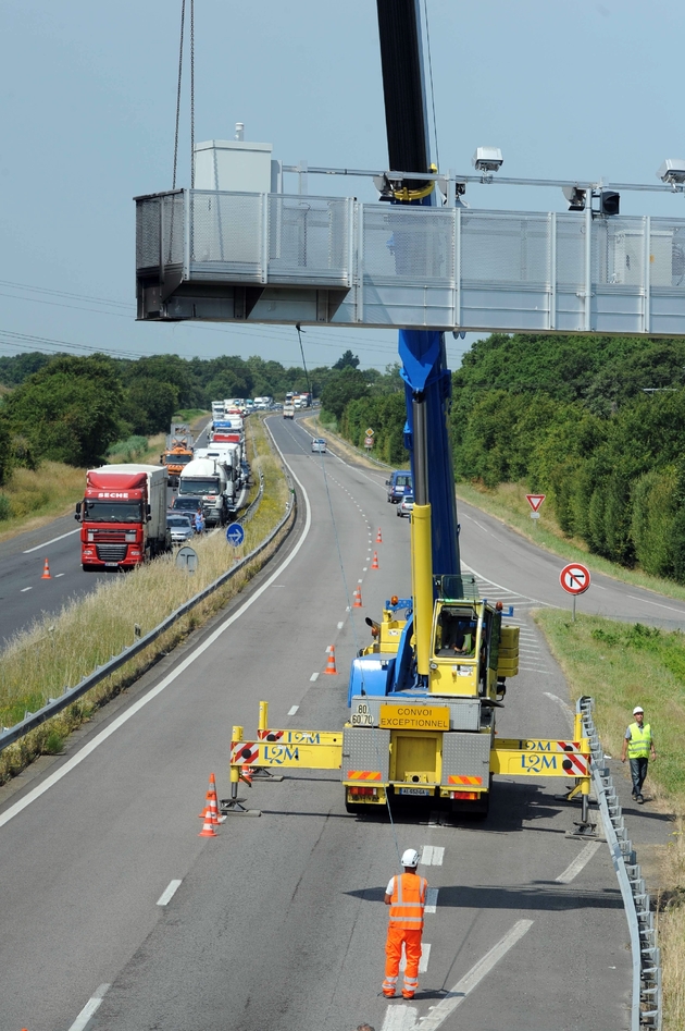 Démantèlement d'un pont routier, mis en place pour collecter l'écotaxe, le 23 juin 2014 près de Prinquiau, sur la N171 entre Nantes et Saint-Nazaire